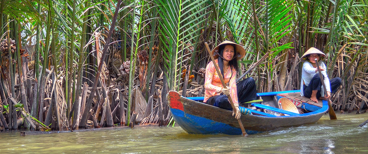 Vietnamese women in ao dai at My Tho, Mekong Delta